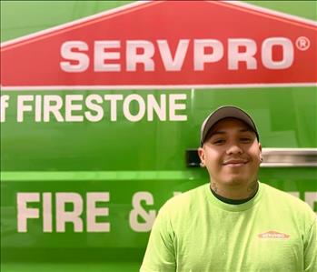 SERVPRO employee in front of green truck