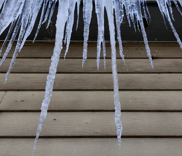 icicles hanging from gutters of a home