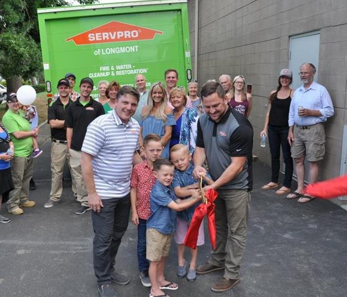 a group of people in front of a SERVPRO truck